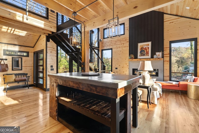 73 Cannon St, Clayton, GA 30525 - dining room featuring stairway, wooden walls, wooden ceiling with exposed beams, a large fireplace, and a towering ceiling