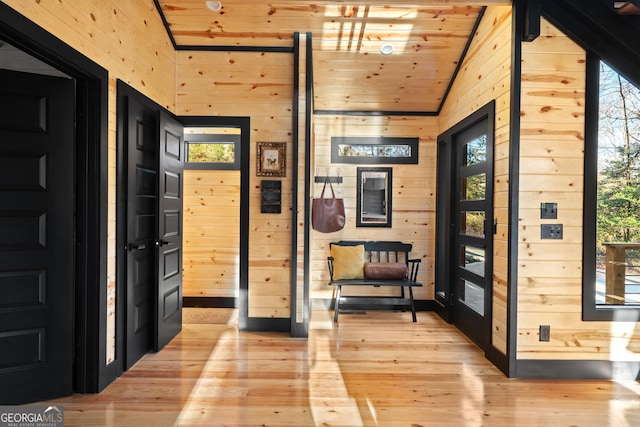 foyer entrance with plenty of natural light, wooden ceiling, vaulted ceiling, and light wood-type flooring