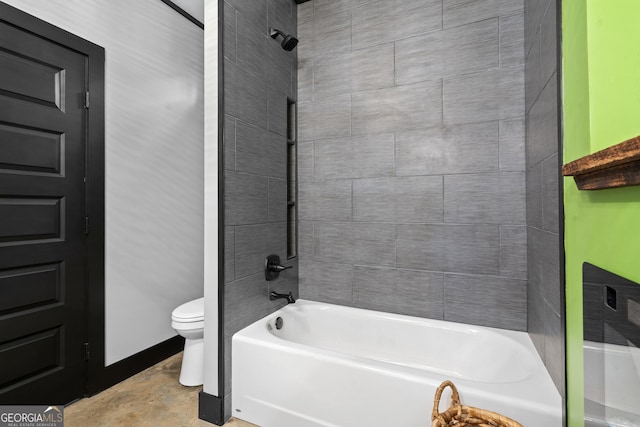 bathroom with tiled shower / bath combo and toilet