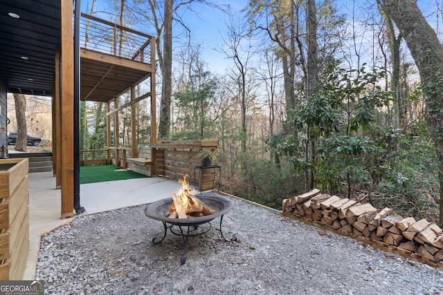 exterior space featuring a patio and a fire pit