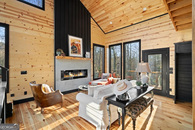 living room featuring wooden walls, high vaulted ceiling, wooden ceiling, and light wood-type flooring