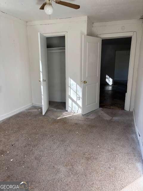 161 Cotton St, Commerce, GA 30529 - unfurnished bedroom with ceiling fan, a closet, and carpet floors