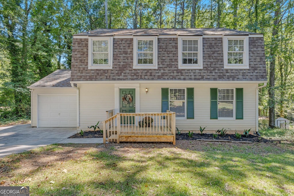 view of front of property with a garage and a front lawn