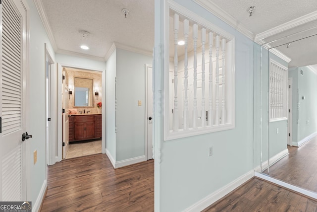 hallway featuring a textured ceiling, crown molding, and dark hardwood / wood-style floors