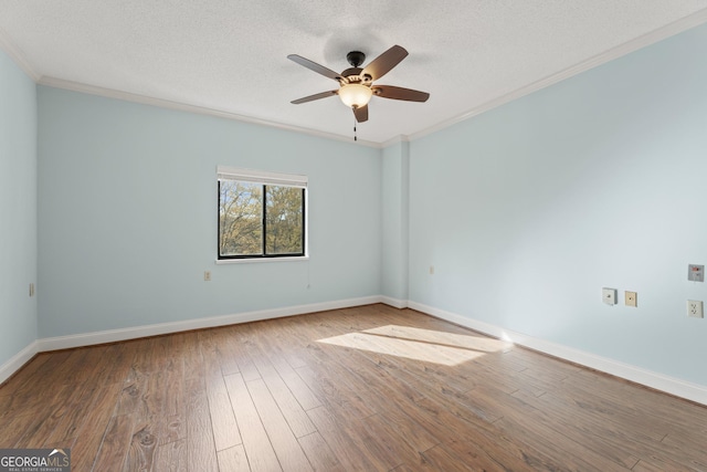 unfurnished room with hardwood / wood-style floors, ceiling fan, and crown molding