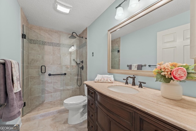 bathroom featuring toilet, vanity, a textured ceiling, and walk in shower