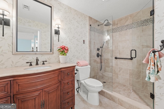 bathroom with vanity, a shower with shower door, a textured ceiling, and toilet