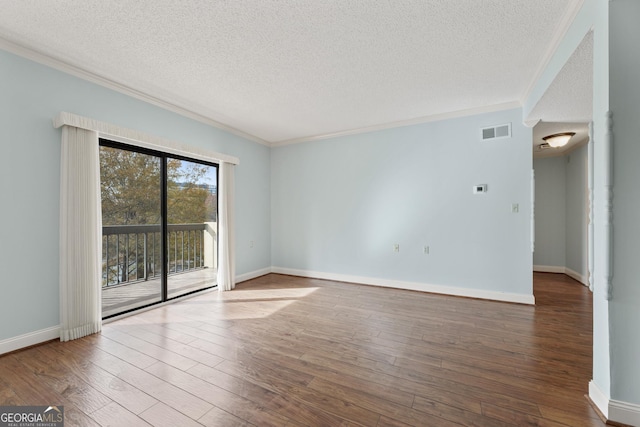 empty room with crown molding, a textured ceiling, and hardwood / wood-style flooring