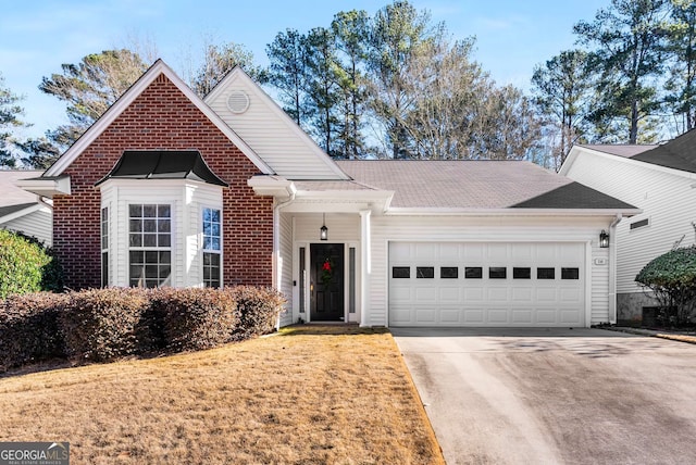 view of front of home with a garage and a front yard