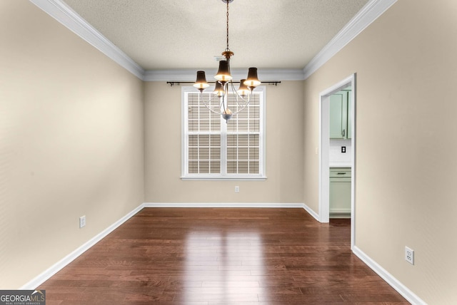 unfurnished dining area featuring a textured ceiling, crown molding, dark hardwood / wood-style floors, and a notable chandelier