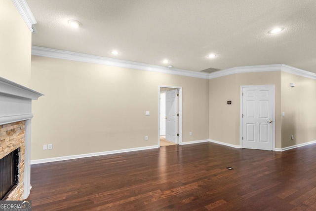 unfurnished living room with crown molding, a fireplace, and dark wood-type flooring