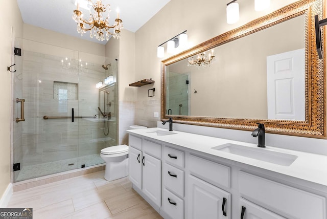 bathroom featuring vanity, tile patterned floors, toilet, walk in shower, and a chandelier