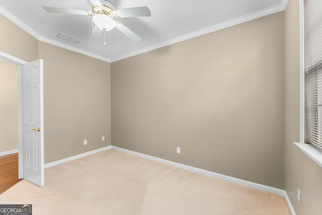 unfurnished bedroom featuring ceiling fan, crown molding, and light carpet