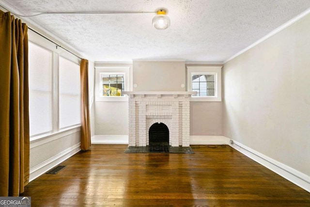 unfurnished living room featuring a textured ceiling, a fireplace, dark hardwood / wood-style floors, and ornamental molding