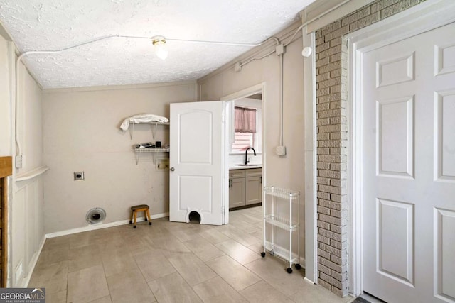 clothes washing area featuring sink, a textured ceiling, and hookup for an electric dryer