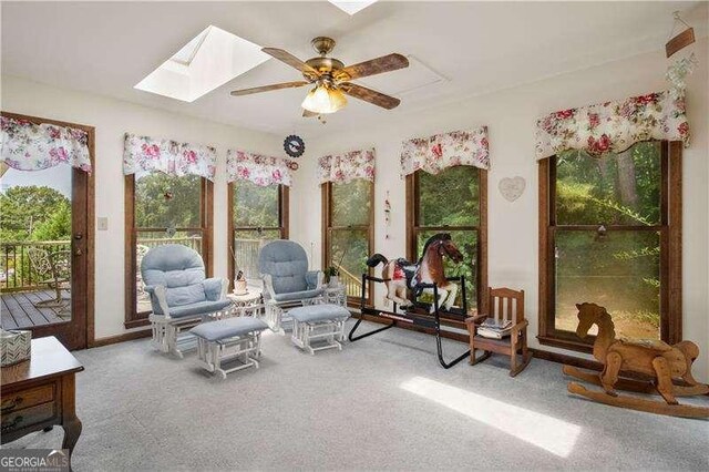 sunroom / solarium featuring a skylight and ceiling fan