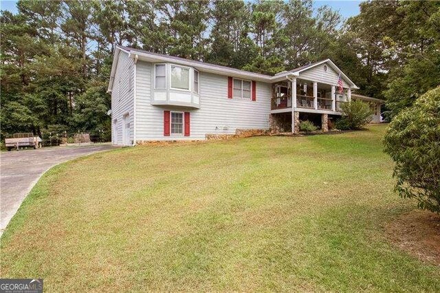 view of front of house featuring a garage and a front lawn