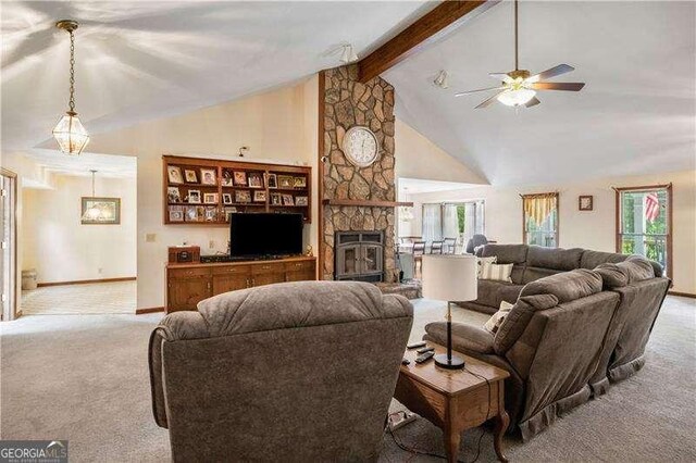 carpeted living room featuring a fireplace, ceiling fan, plenty of natural light, and beamed ceiling