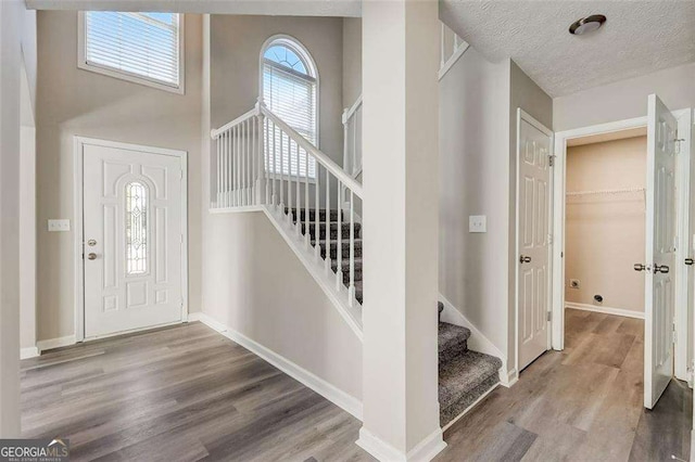 entrance foyer featuring hardwood / wood-style floors and a textured ceiling