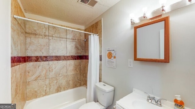 full bathroom with shower / bath combination with curtain, toilet, a textured ceiling, and vanity