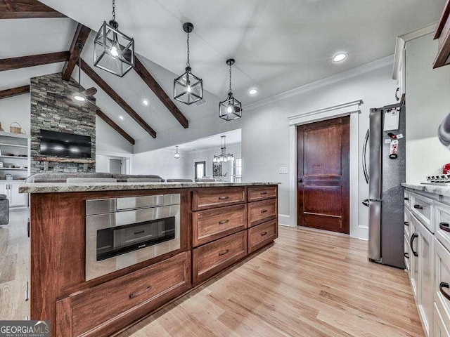 kitchen featuring lofted ceiling with beams, pendant lighting, light hardwood / wood-style floors, white cabinets, and appliances with stainless steel finishes