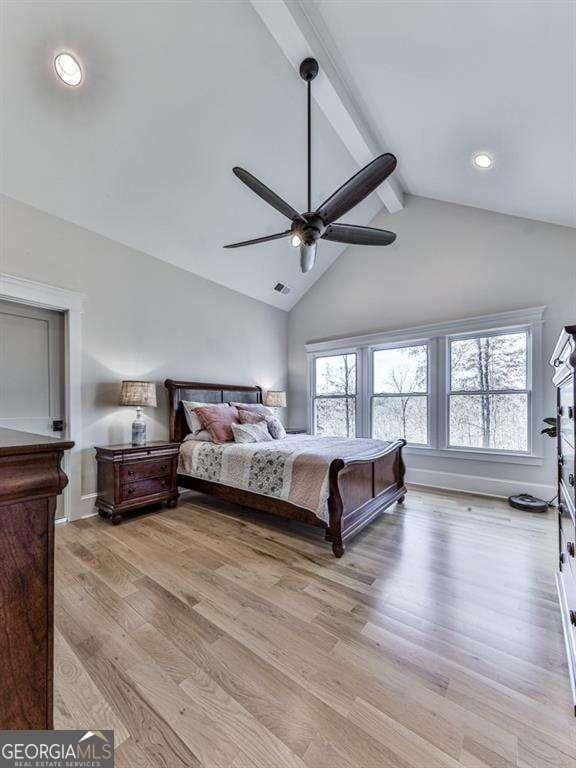 bedroom featuring ceiling fan, beam ceiling, high vaulted ceiling, and light hardwood / wood-style flooring