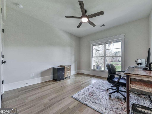 office space with ceiling fan and light hardwood / wood-style flooring