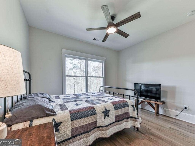 bedroom featuring hardwood / wood-style floors and ceiling fan