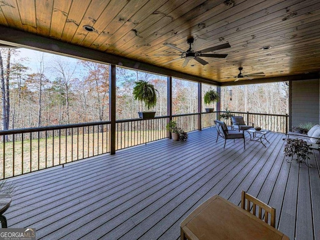 wooden terrace featuring ceiling fan