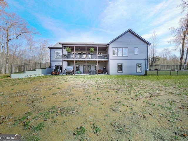 back of house featuring a lawn