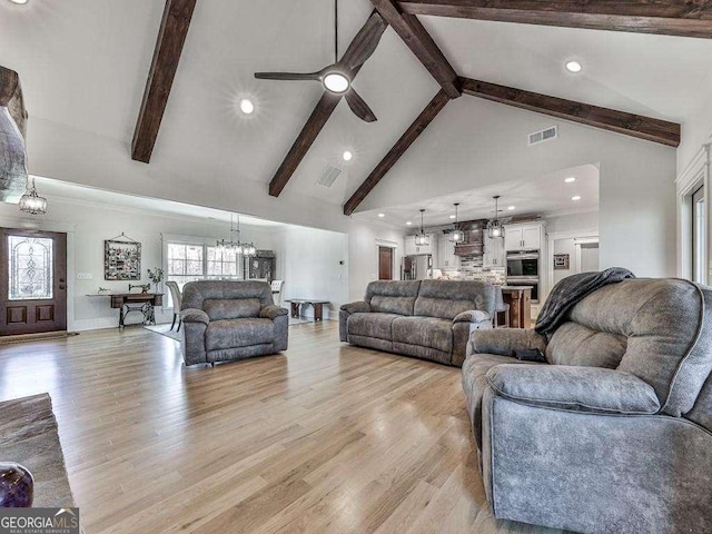 living room featuring beamed ceiling, light hardwood / wood-style floors, high vaulted ceiling, and plenty of natural light