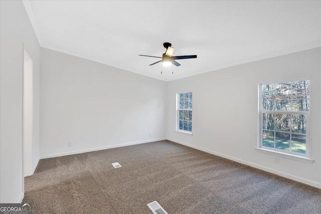 carpeted empty room with ceiling fan and ornamental molding