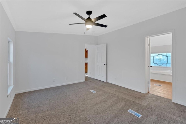 unfurnished bedroom featuring ceiling fan and carpet