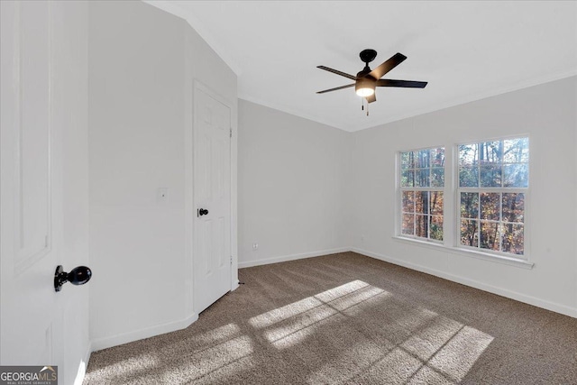 empty room featuring dark carpet and ceiling fan