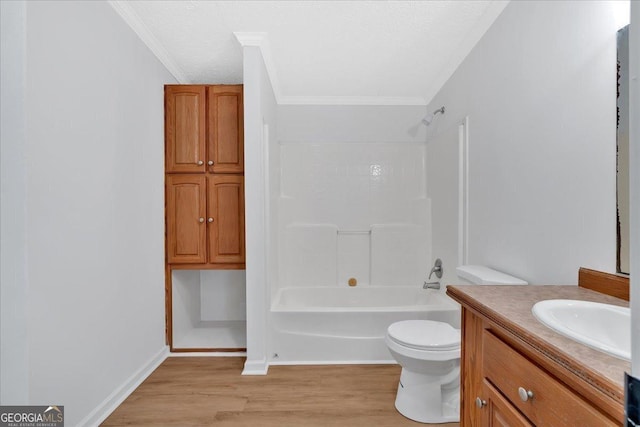 full bathroom with wood-type flooring, toilet, shower / washtub combination, vanity, and ornamental molding