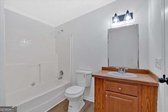 full bathroom with vanity, crown molding, washtub / shower combination, hardwood / wood-style floors, and toilet