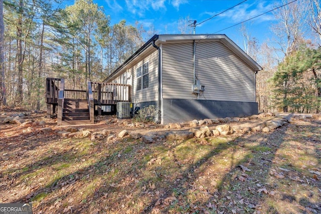 view of property exterior featuring a deck and central air condition unit