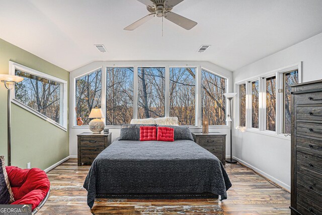 living area featuring ceiling fan, lofted ceiling, and dark wood-type flooring