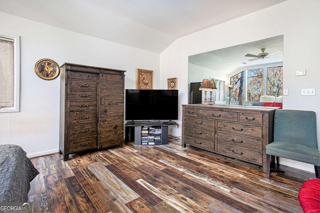 sitting room featuring vaulted ceiling, ceiling fan, and dark wood-type flooring