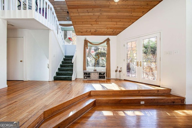 interior space with hardwood / wood-style flooring, wooden ceiling, high vaulted ceiling, and french doors