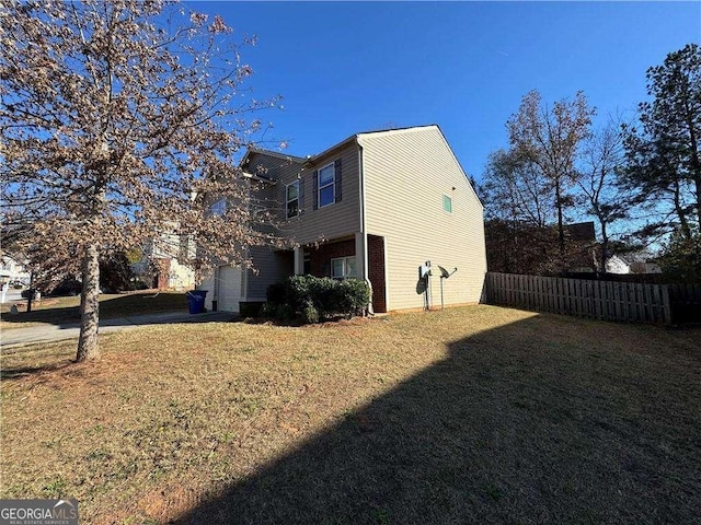 view of home's exterior with a yard and a garage