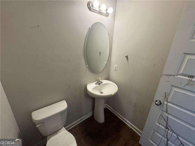 bathroom featuring hardwood / wood-style floors and toilet