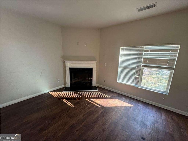 unfurnished living room featuring dark wood-type flooring