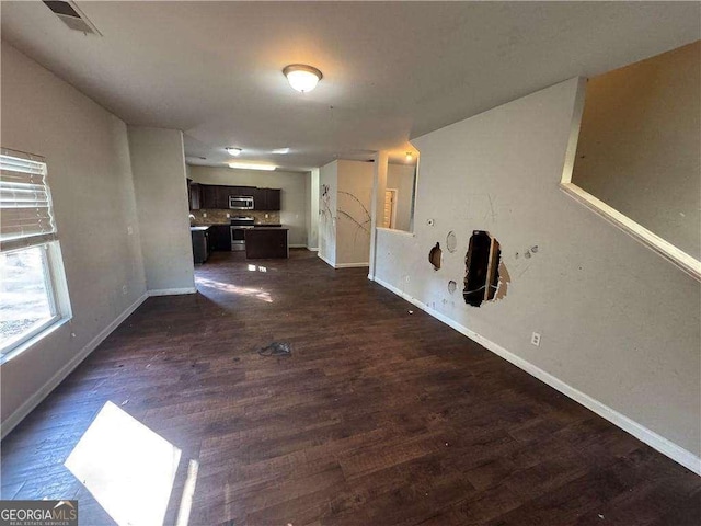 unfurnished living room with dark wood-type flooring