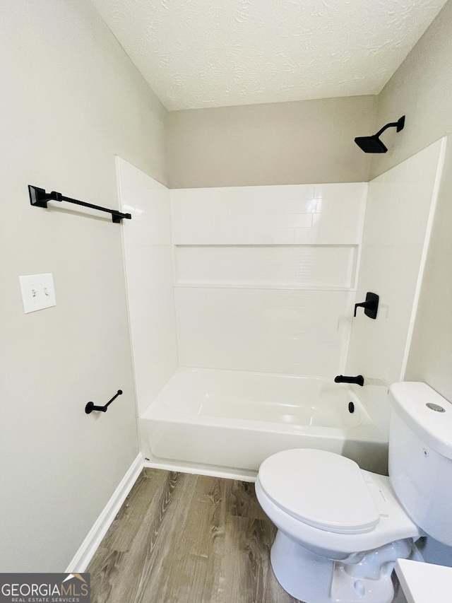 carpeted empty room featuring ceiling fan and a textured ceiling