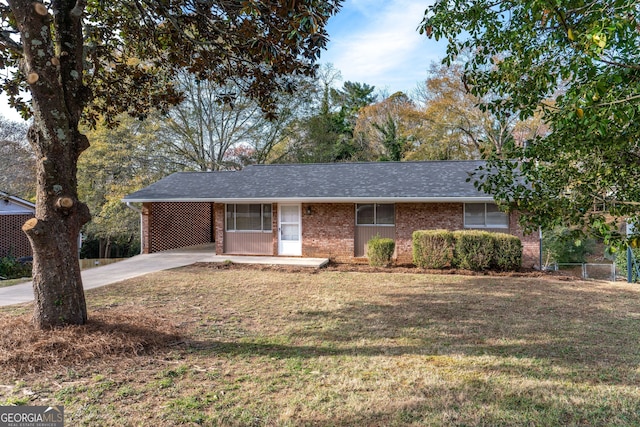 ranch-style home with a carport and a front yard