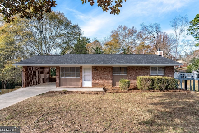 ranch-style home with a front yard and a carport