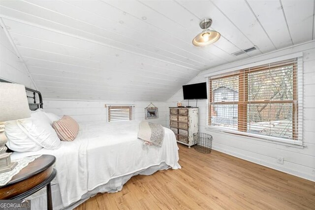 bedroom featuring lofted ceiling, wood-type flooring, and wooden ceiling