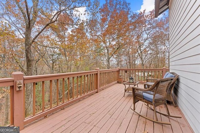 wooden deck with an outdoor living space