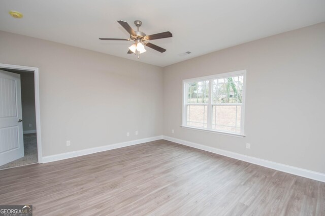 unfurnished bedroom featuring ceiling fan, light colored carpet, and a closet